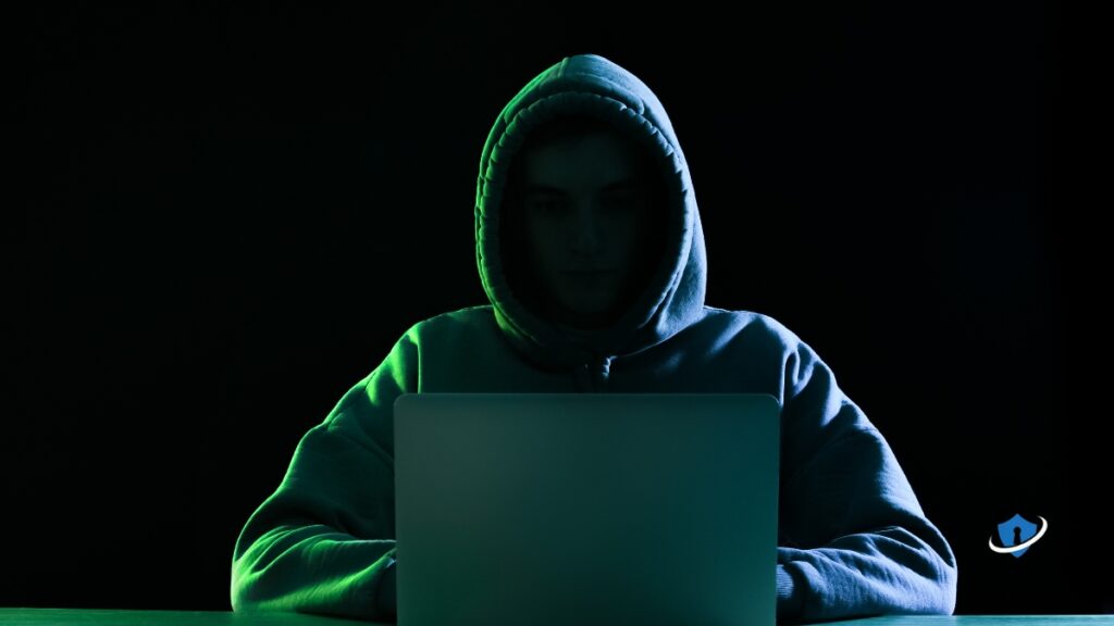 Hacker sitting in front of a laptop.