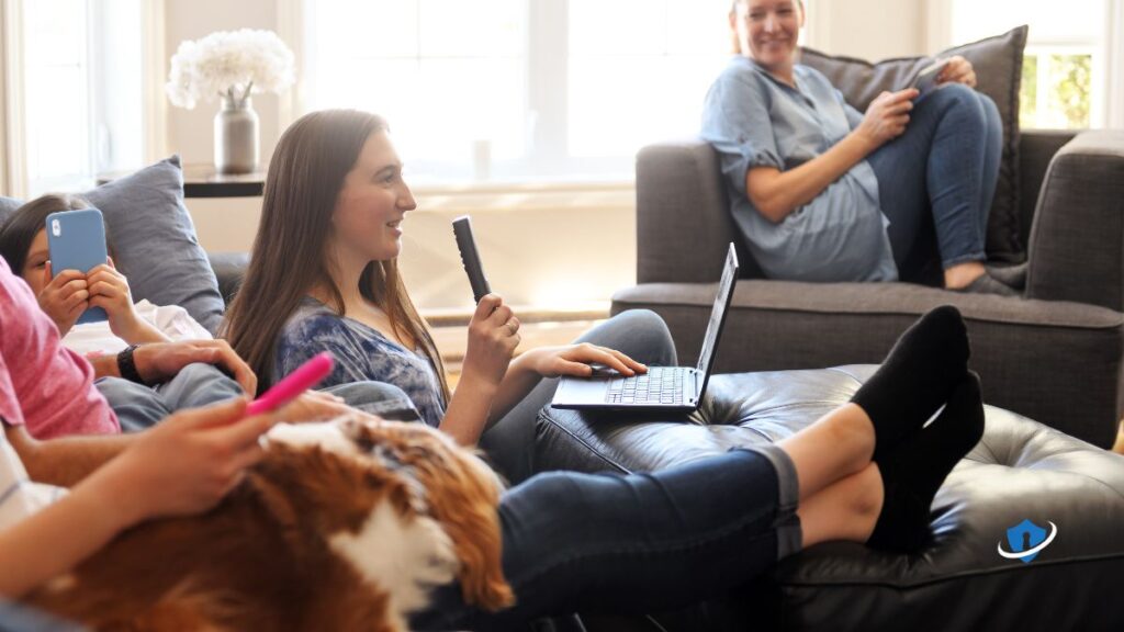 A family using Wi-Fi securely (smiling with laptops/phones).